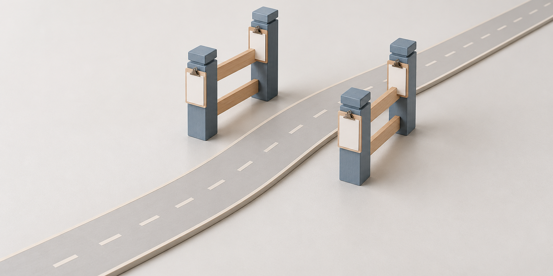 A road passing through a four-post gate, each post holding a blank checklist plate beside the route.
